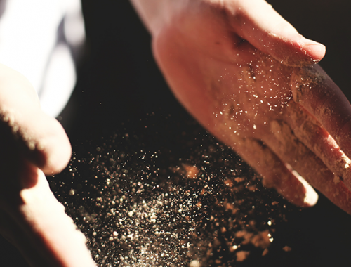 Hands pouring flour