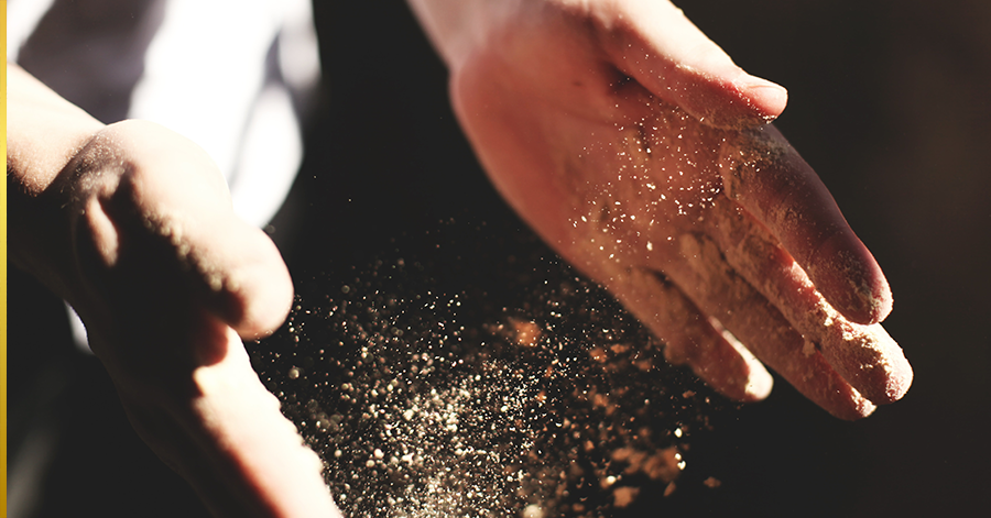 Hands pouring flour