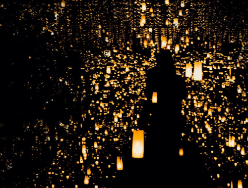 Person walking towards yellow lanterns